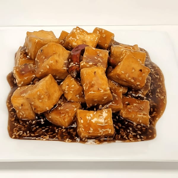 Double Happy's sesame tofu, coated in a rich brown sauce and sprinkled with sesame seeds.