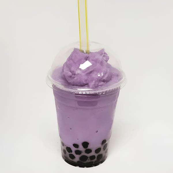 A Double Happy taro bubble tea with black boba, purple slush, and a yellow straw.